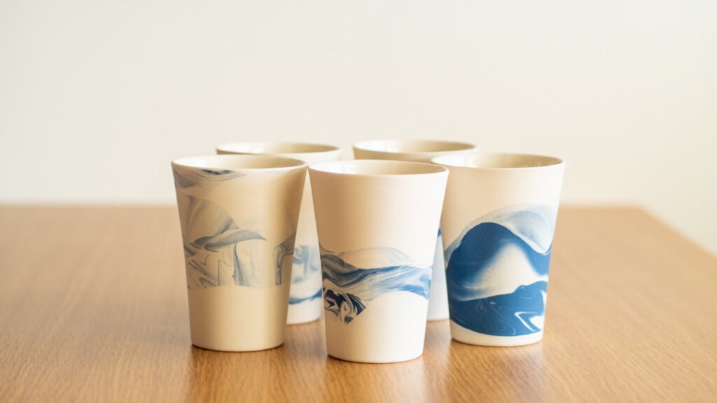 Five tumblers with wavy blue patterns