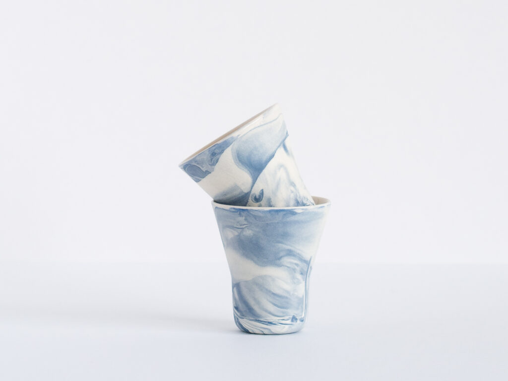 Two small sake cups with a marbled blue pattern